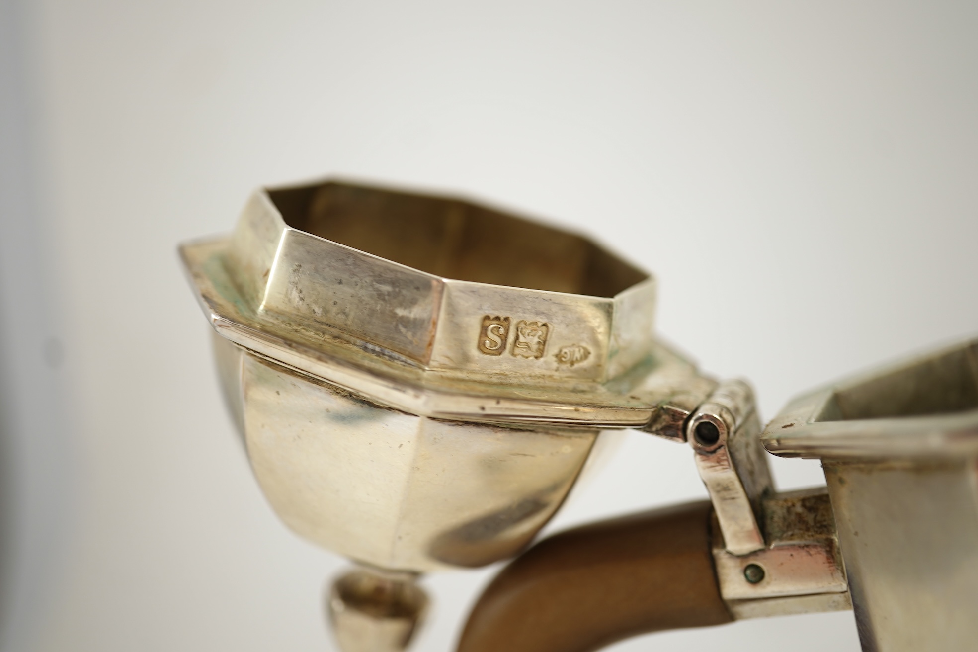 A pair of George V octagonal silver café au lait pots, by William Comyns & Sons Ltd
